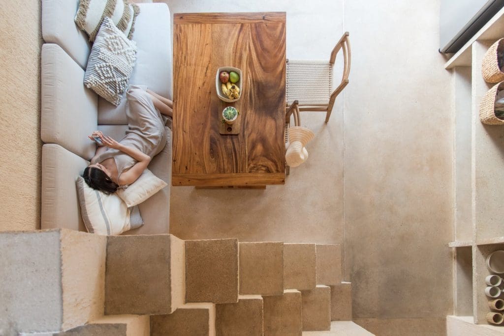This Pink Tiny House in Mexico Is a Millennials Dream Come True 4 The condensed, double-height footprint fits a combination living/dining/kitchen area on the main floor and a bedroom on the mezzanine.