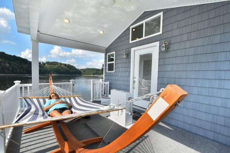 Float Your Cares Away on This Incredible Tiny Houseboat 7 Tiny houseboat covered porch 768x512 1