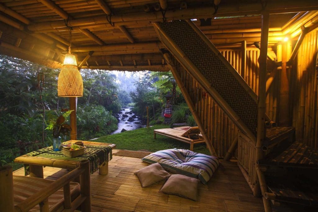 This Serene Bamboo Bungalow Rental Is a Slice of Paradise in Bali 14 Set amidst a stunning forest in Bali, this charming bamboo bungalow offers visitors a unique and peaceful experience. The bamboo bungalow is located on the banks of a river, providing guests with beautiful views.