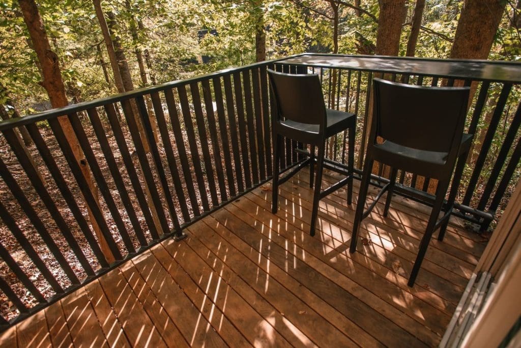 The Nook is a Cabin Style Tiny House with an Enchanting Mix of Japanese and Scandinavian Style 10 the deck overlooking the surrounding forest is made of locally milled black locust the custom iron railing was done by iron maiden studios a metalshop in asheville