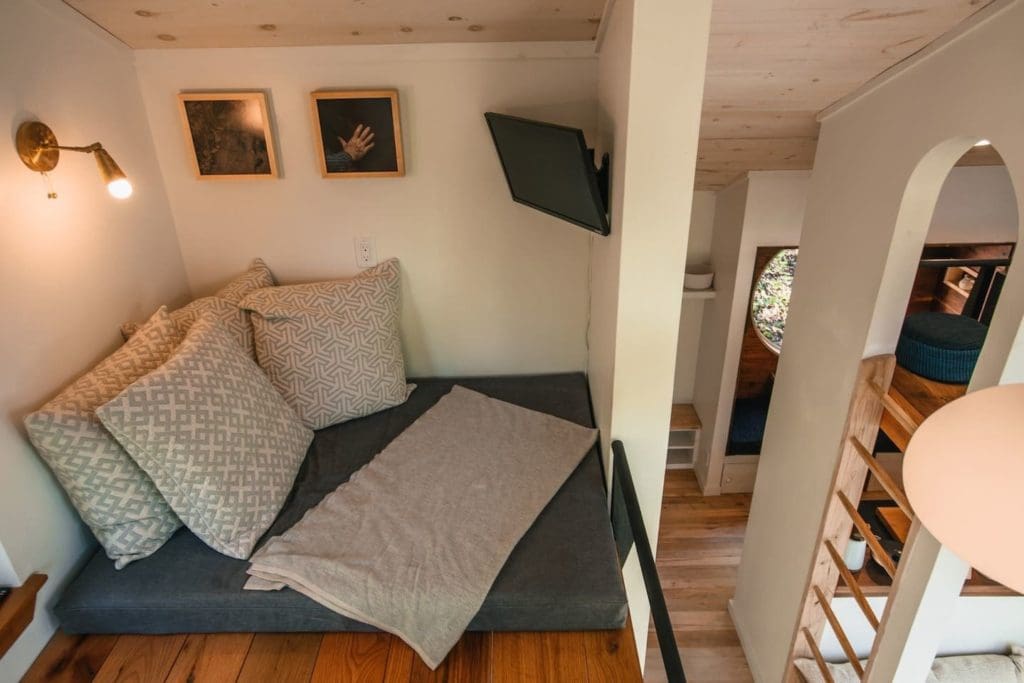 The Nook is a Cabin Style Tiny House with an Enchanting Mix of Japanese and Scandinavian Style 5 the media loft features soft goods made locally by the oriole mill sew co and echo view mill the iron work for the lofts and the side porch railings was done by iron maiden studios in asheville
