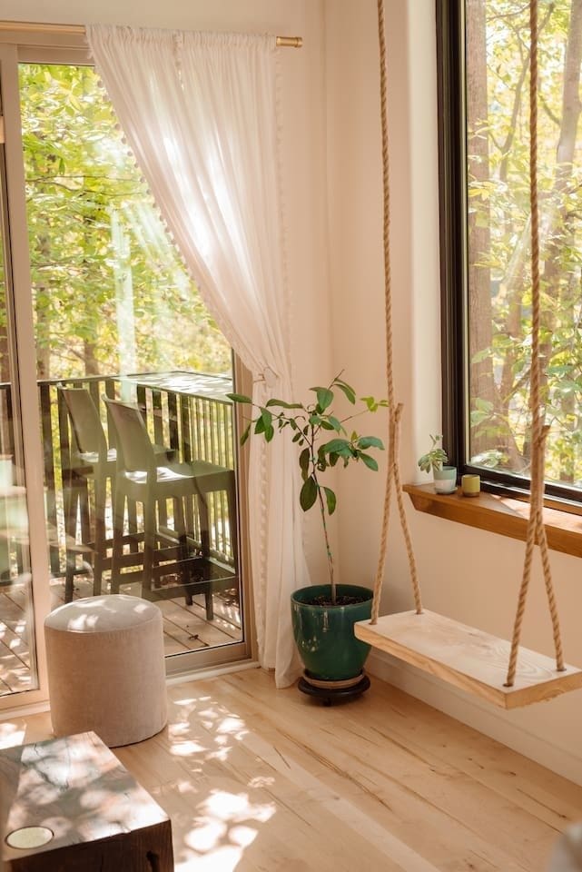 The Nook is a Cabin Style Tiny House with an Enchanting Mix of Japanese and Scandinavian Style 4 the swing in the living room is ash wood the floors is ambrosia maple