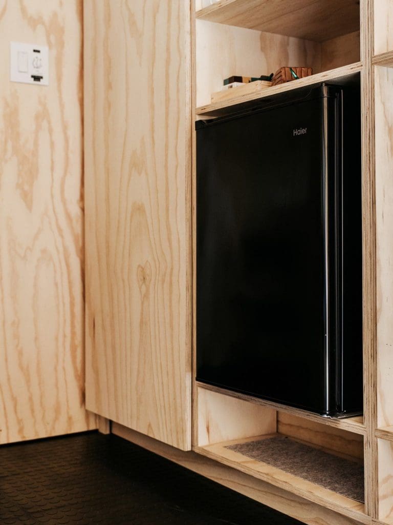 Tiny Cabin Retreat Reconnects Its Guests With Nature 6 Austin Texas Ryan McLaughlin Cabin fridge storage