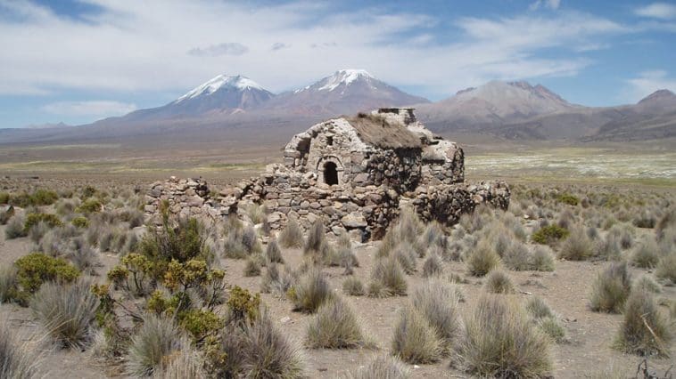 B48 Deserted house at Sajama with twin volcanos behind