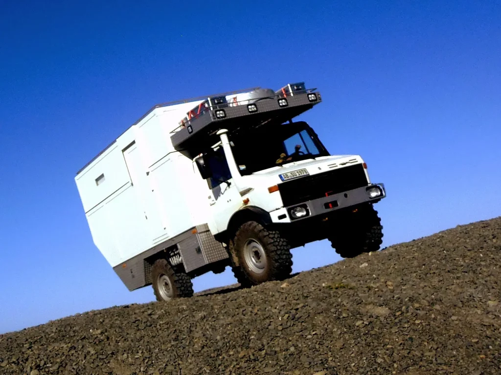 Choosing the Perfect Unimog Camper for Your Off-Road Lifestyle 5 An owner performing maintenance on their Unimog camper, emphasizing the importance of regular care and upkeep.