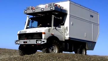 A Unimog camper traversing rugged off-road terrain, showcasing its exceptional capabilities.