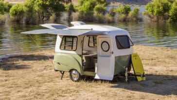 A well-equipped mini camper set up at a scenic location, illustrating the perfect balance of comfort and compactness.