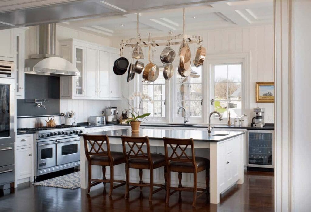 Small Kitchen Hacks: 25 Simple Tricks to Maximize Your Space and Efficiency 8 A kitchen ceiling rack with hanging hooks holding pots and pans, saving cabinet and counter space.