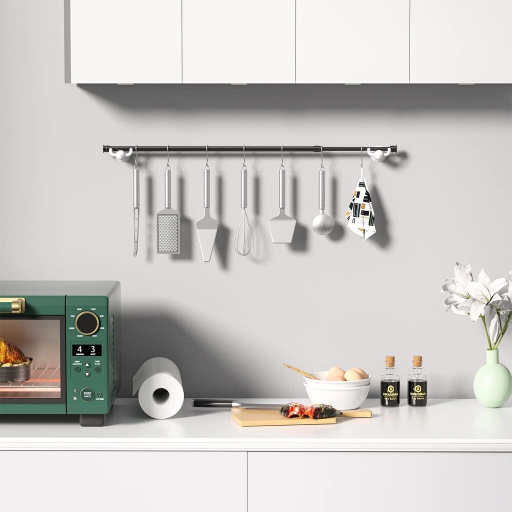 Small Kitchen Hacks: 25 Simple Tricks to Maximize Your Space and Efficiency 3 Small Kitchen Hacks - A tension rod installed in a small kitchen to organize cooking utensils and keep them within reach.