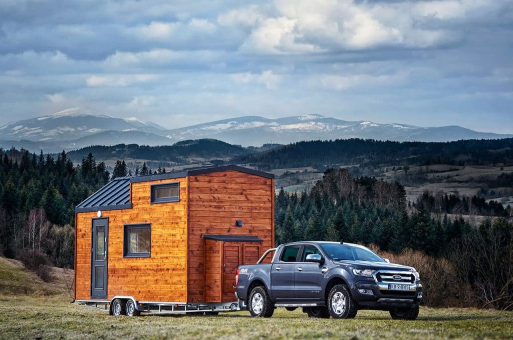 These Tiny House On Wheels Designs and Ideas are Downright Inspiring 65 The charming exterior of the Sunshine tiny house, featuring a traditional gabled roof made of lightweight and durable aluminum.