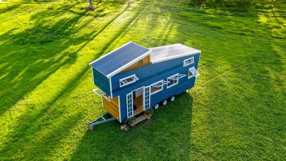 A unique gooseneck tiny home because of its pop-up roof