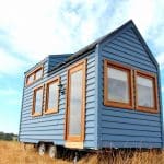 The Colonial Blue is a beautiful blue tiny house with Meranti wood trim and front door