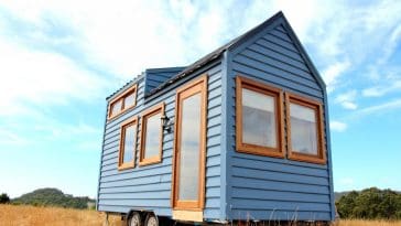 The Colonial Blue is a beautiful blue tiny house with Meranti wood trim and front door