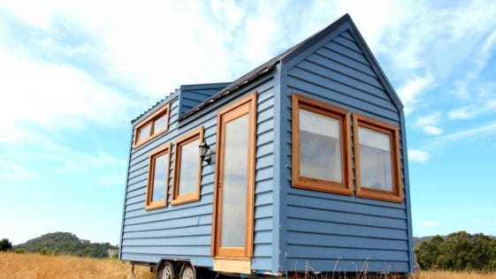 The Colonial Blue is a beautiful blue tiny house with Meranti wood trim and front door
