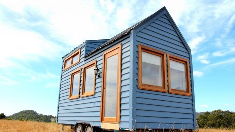 The Colonial Blue is a beautiful blue tiny house with Meranti wood trim and front door