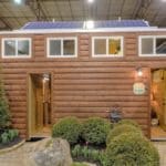 a shipping container tiny house with a rustic log cabin theme