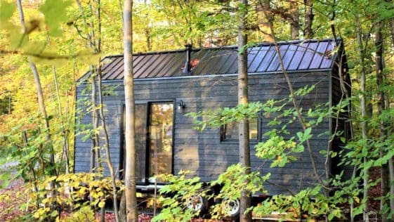 The 256-square-foot cabin is 20-feet long and can accommodate up to five people between its two lofts and sleeper sofa.