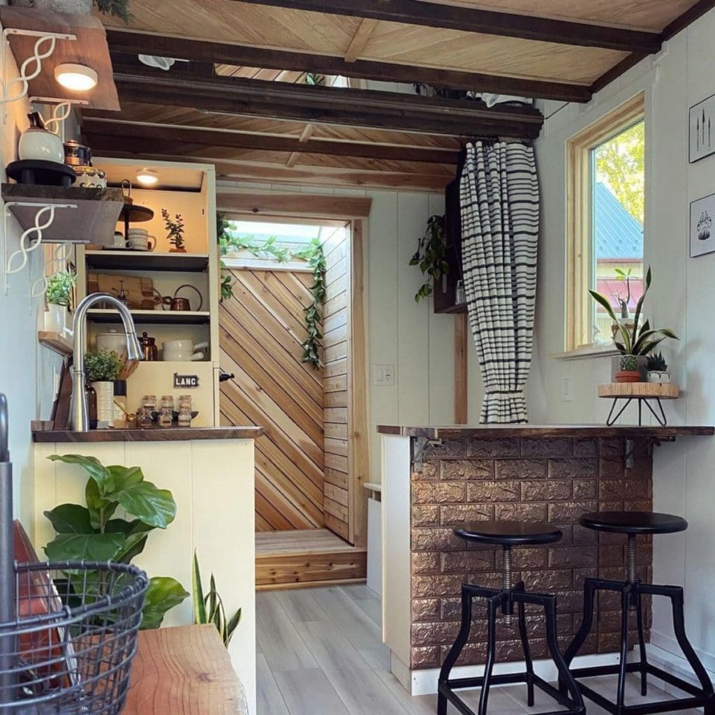 The Mountain Tiny House Is A Whimsical Tiny Retreat On Wheels 2 Tiny house on wheels - Dinning area and behind it is the shower and toilet area