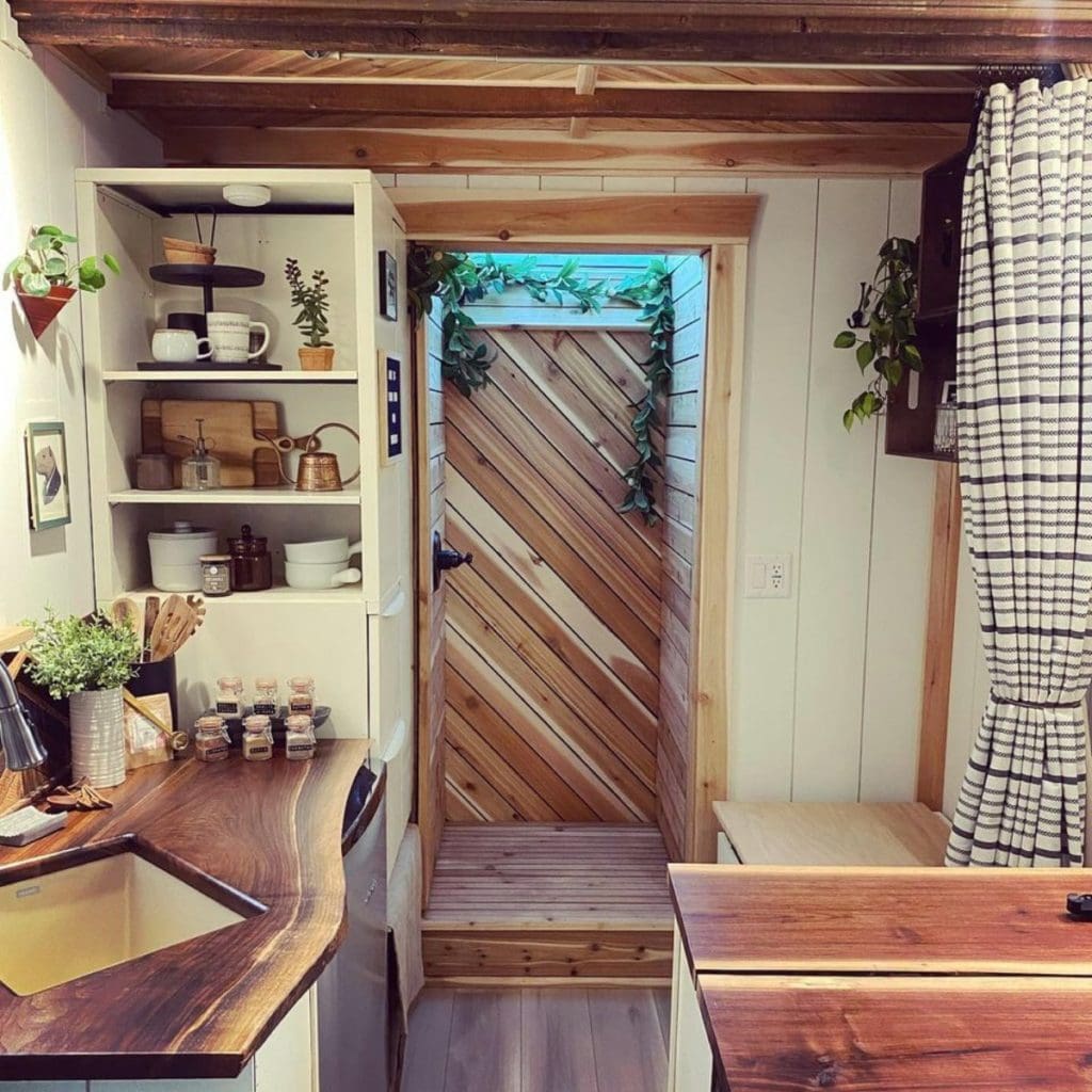 The Mountain Tiny House Is A Whimsical Tiny Retreat On Wheels 3 Tiny house on wheels - Dinning area and behind it is the shower and toilet area