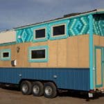 This Vibrant Tiny House House Features A Beach Theme With Its Ocean Blue Metal Skirt With Green And Blue Shingles