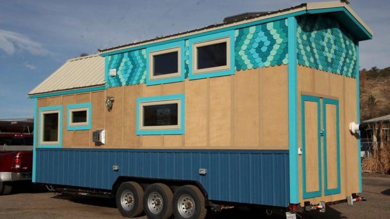 This Vibrant Tiny House House Features A Beach Theme With Its Ocean Blue Metal Skirt With Green And Blue Shingles