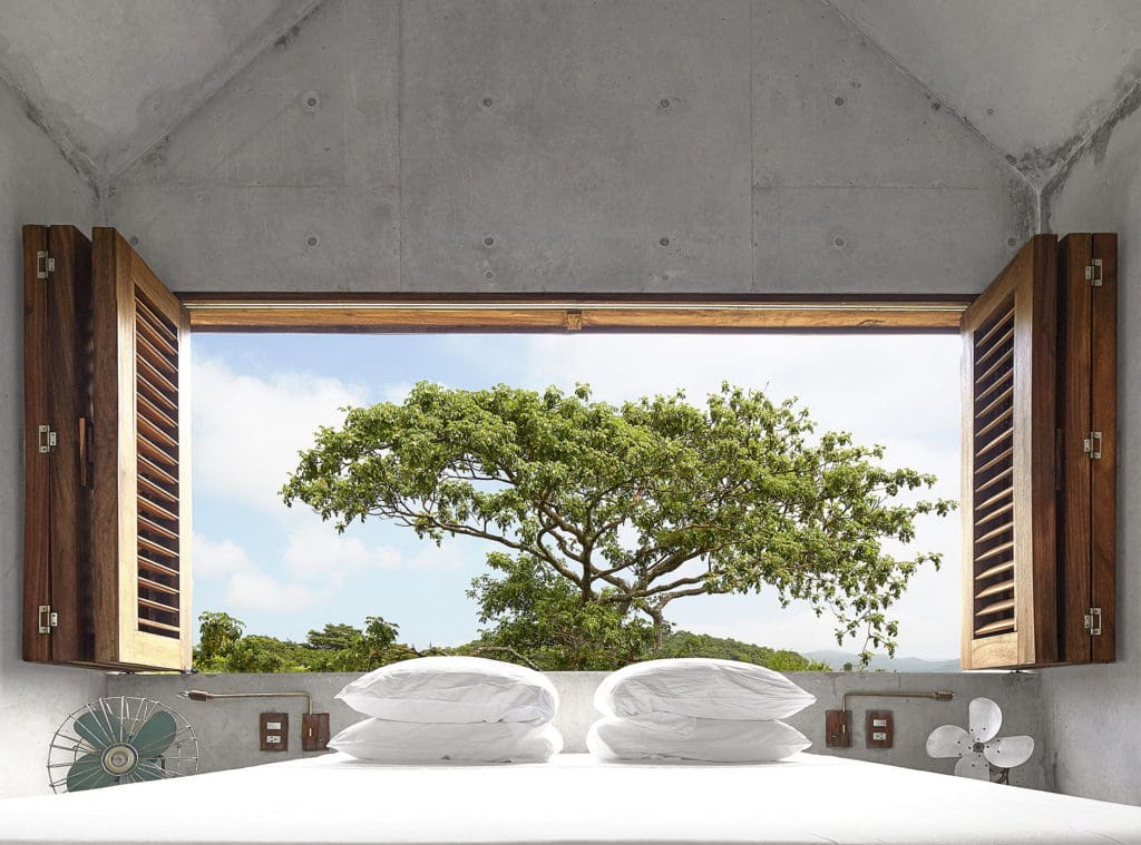 Find tranquility at Casa Tiny: A Beautiful Tiny House in Mexico 32 The masters bedroom at Casa Tiny - a beautiful tiny house in Mexico with its lush green view