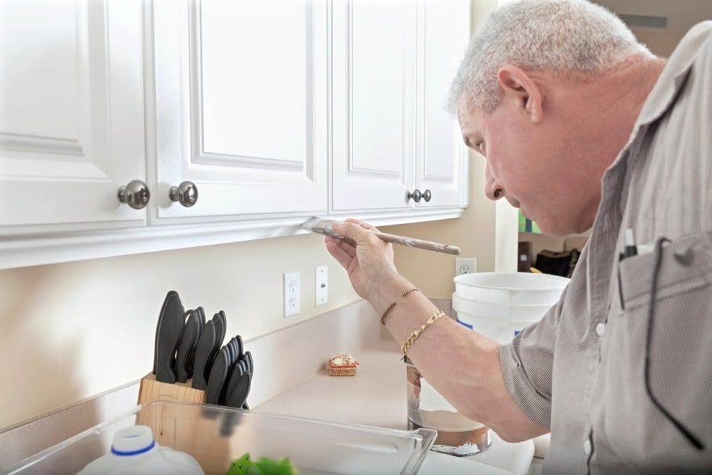 How to Paint Kitchen Cabinets Like A Pro 9 apply coat sealant on kitchen cabinet
