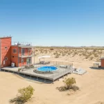 Experience the Ultimate Fusion of Modern and Nature with SkyBox's 3-story shipping container home