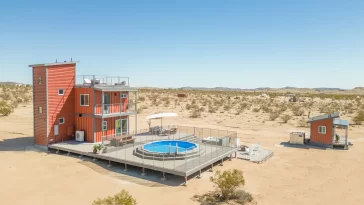 Experience the Ultimate Fusion of Modern and Nature with SkyBox's 3-story shipping container home